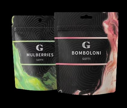 Two sleek black Gotti flower pouches for Mulberries and Bomboloni with vibrant swirl accents