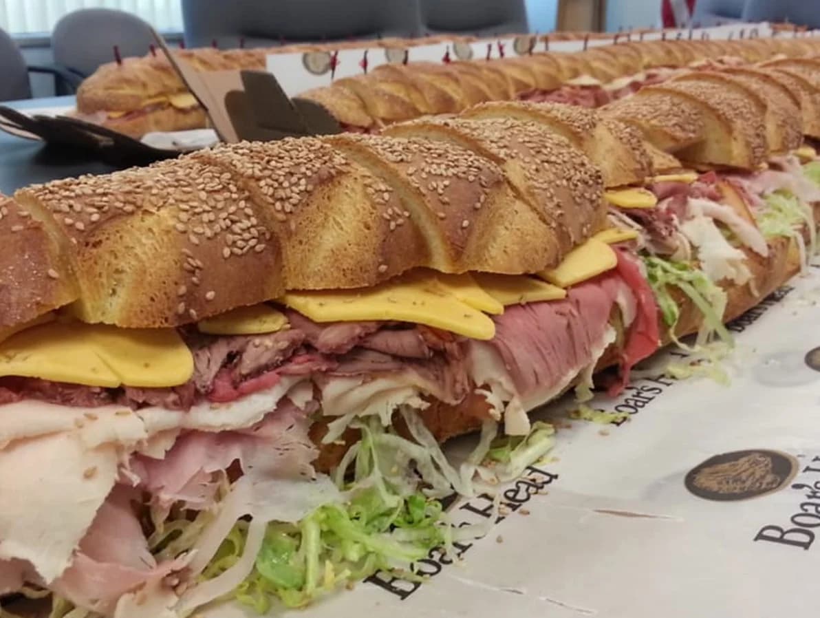 An enormous Boar's Head Italian hero sandwich packed with deli meats, cheese, and shredded lettuce from Joe's Gourmet Meats in Astoria