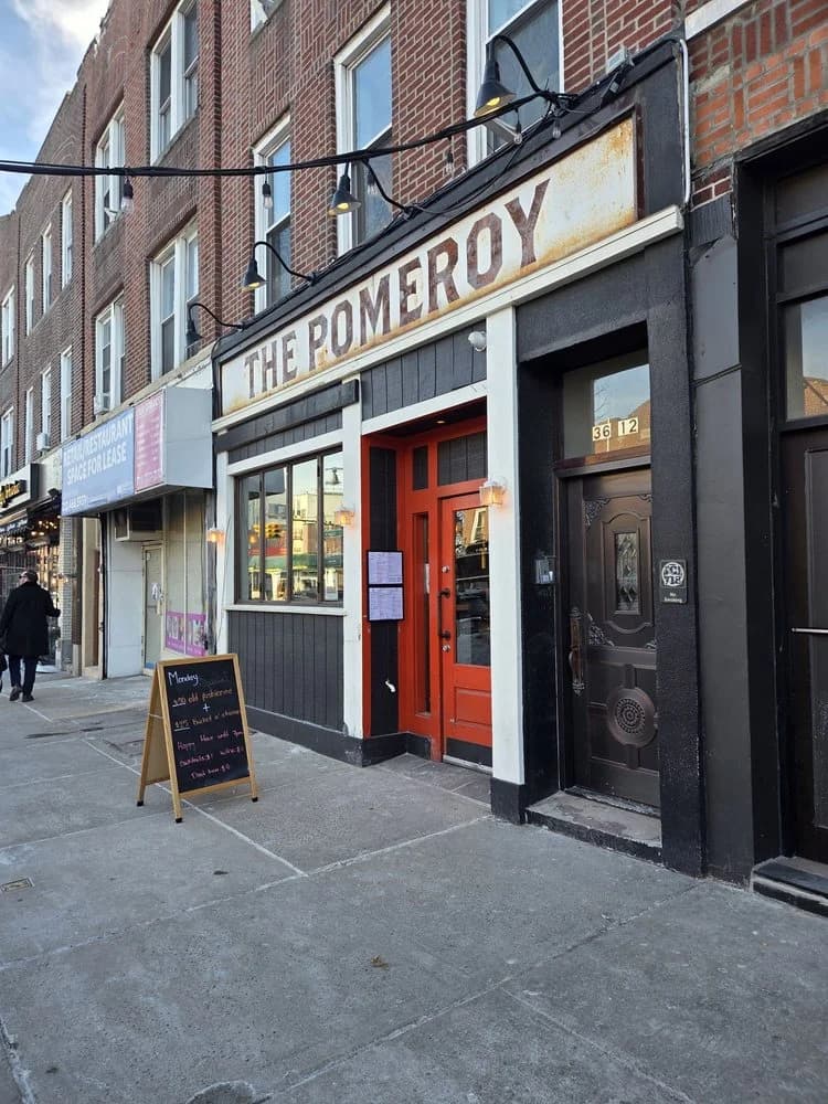 The Pomeroy kitchen and bar storefront with rustic signage and sidewalk menu on Ditmars Boulevard in Astoria