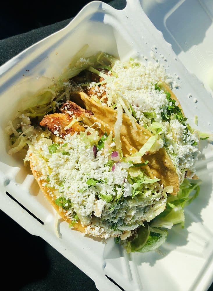 St. James Deli tacos topped with cotija and cilantro, the Taco Deli Spot in Astoria