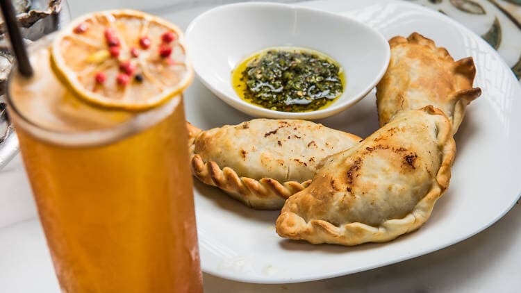 Empanadas with chimichurri and a citrus cocktail at The Last Word in Astoria